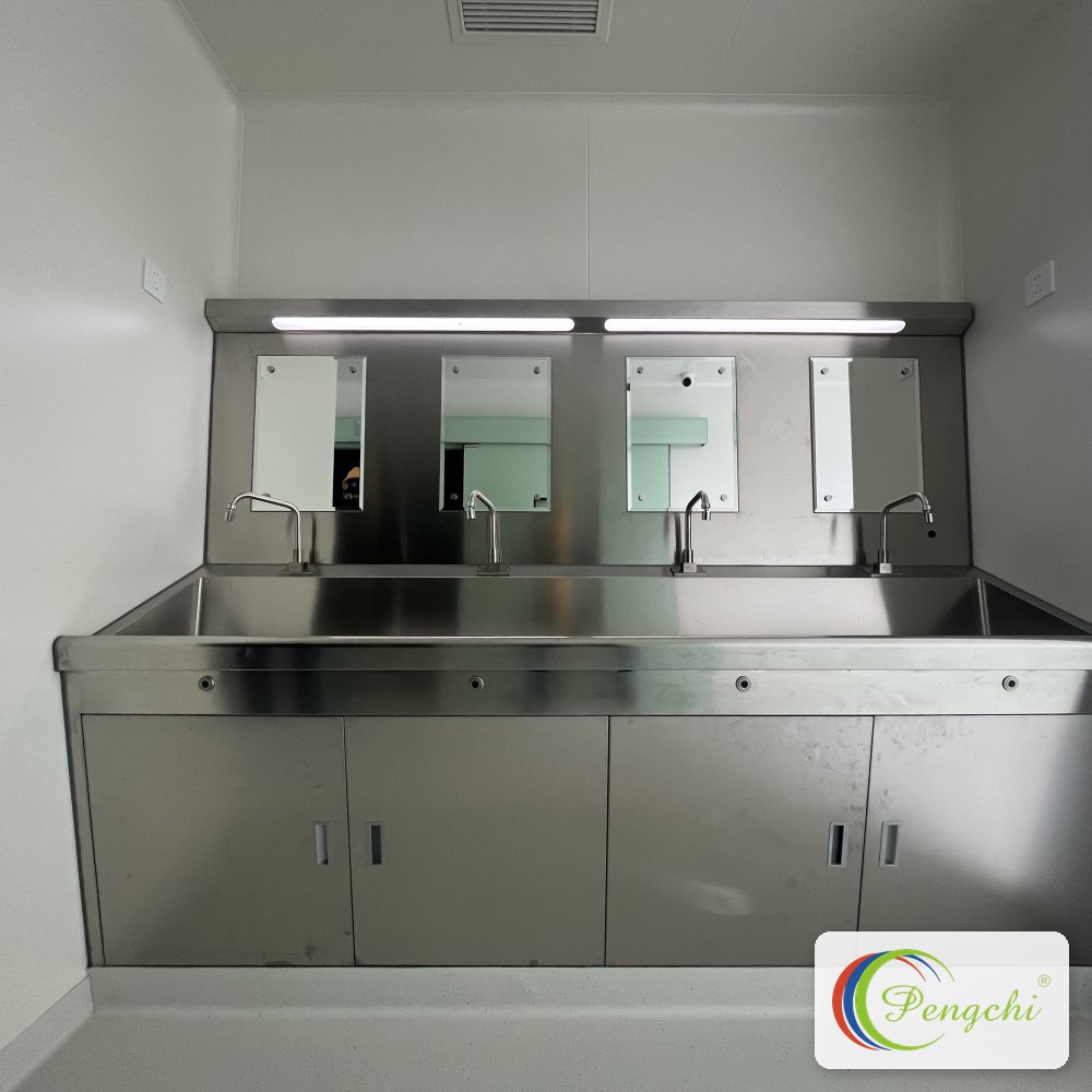 Four-station brushed stainless steel surgical scrub sink with gooseneck faucets, mirrors and LED lighting at Shenzhen Aier Eye Hospital headquarters.