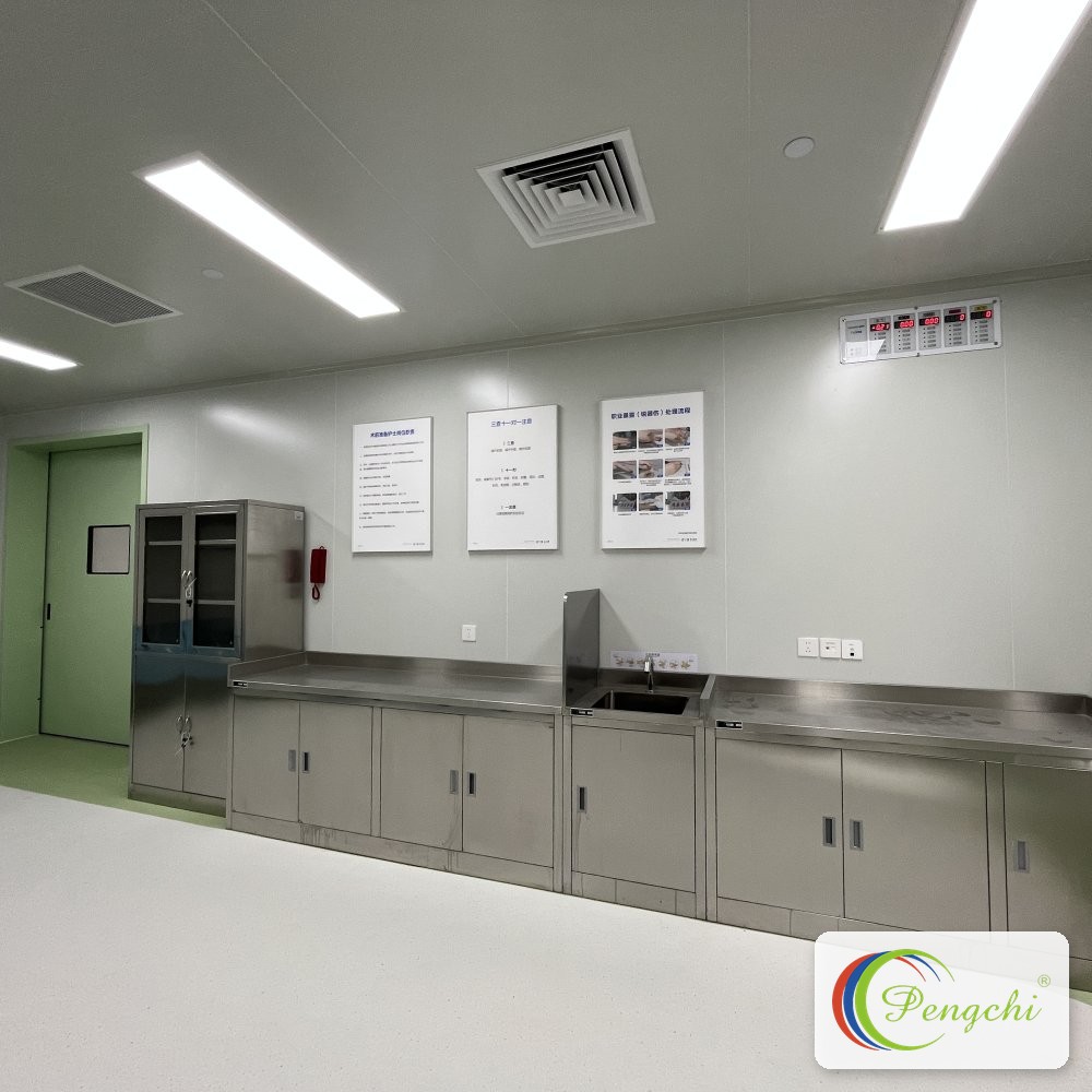 Clinical treatment room fitted with Pengchi stainless steel work counters, central sink and locking glass-fronted instrument cabinet at Shenzhen Aier Eye Hospital.